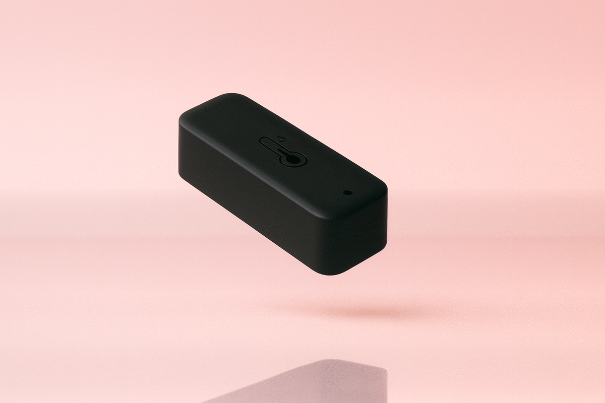 Un capteur de température noir sur un fond rose